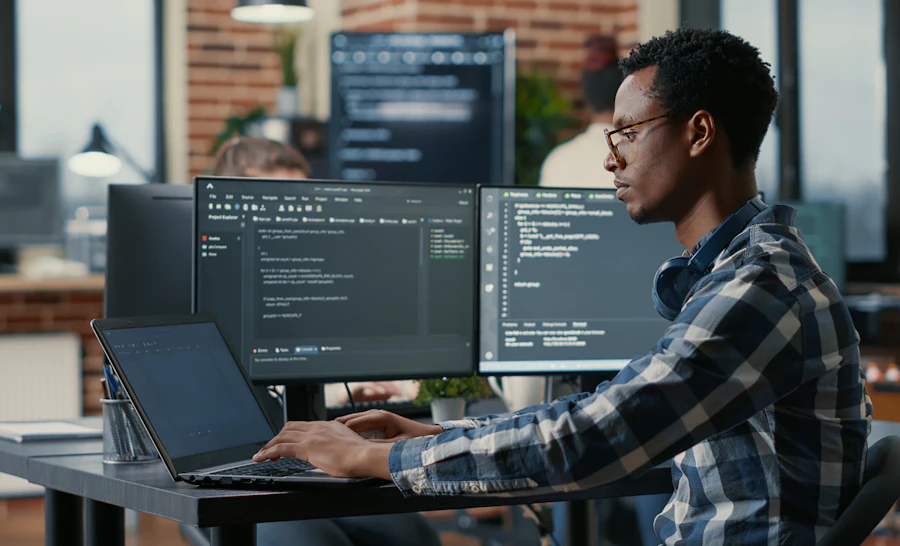Man sitting behind laptop