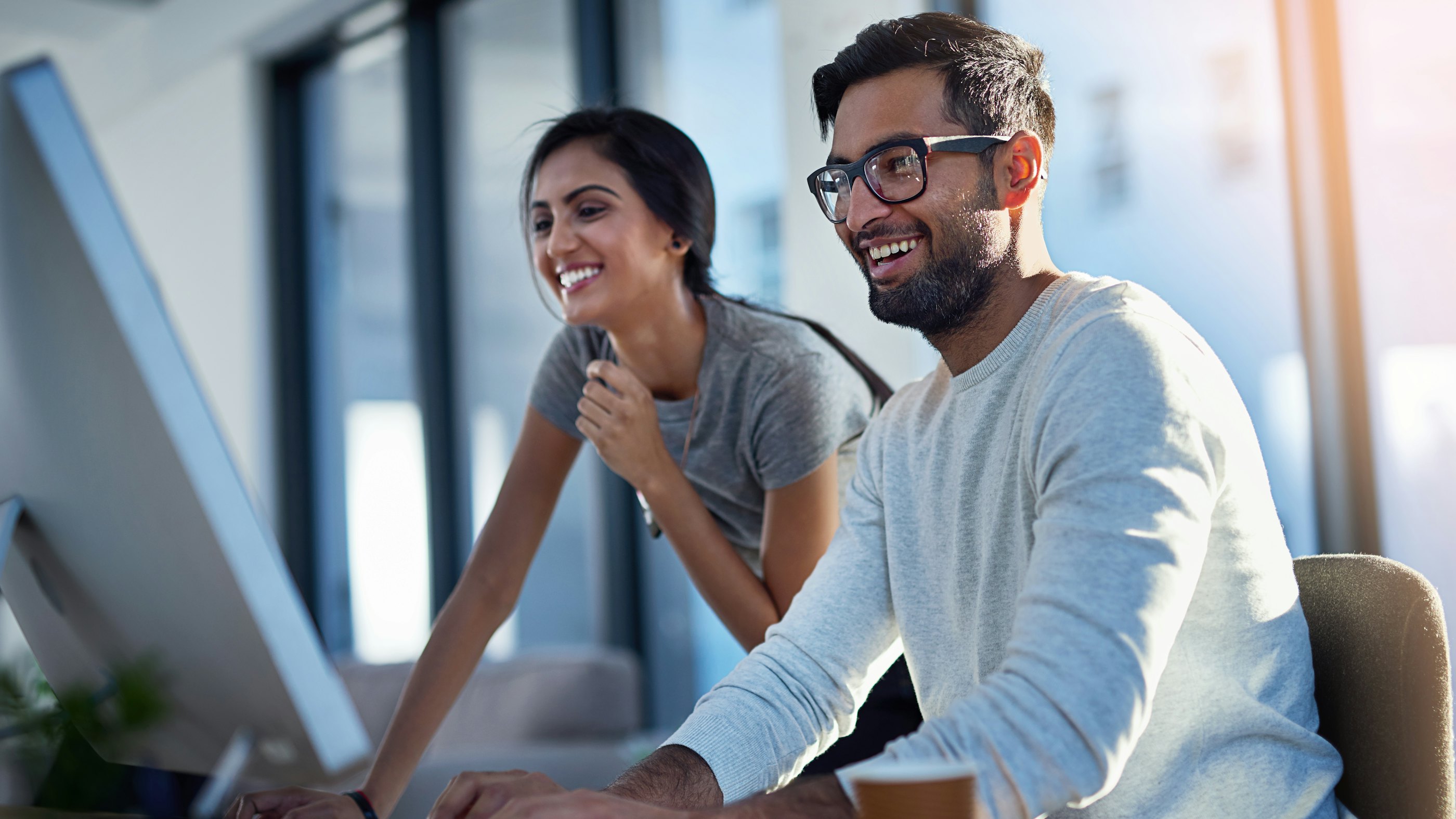 Woman man behind computer screen