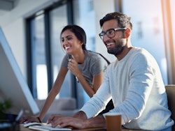 Woman man behind computer screen