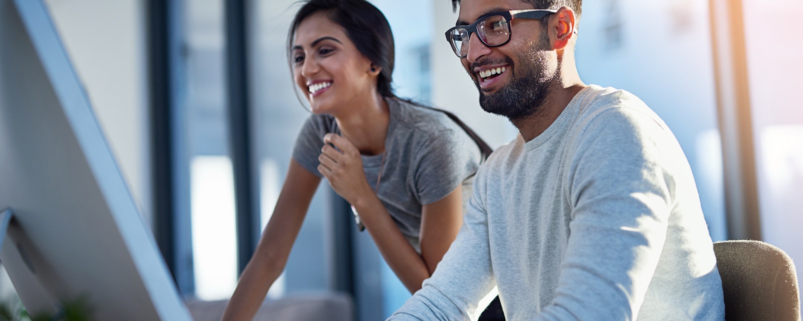 Woman man behind computer screen
