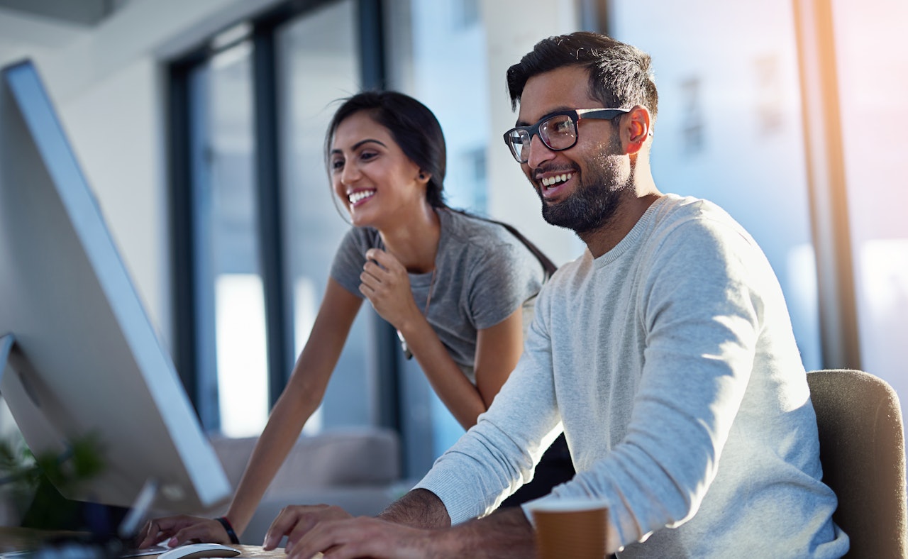 Woman man behind computer screen