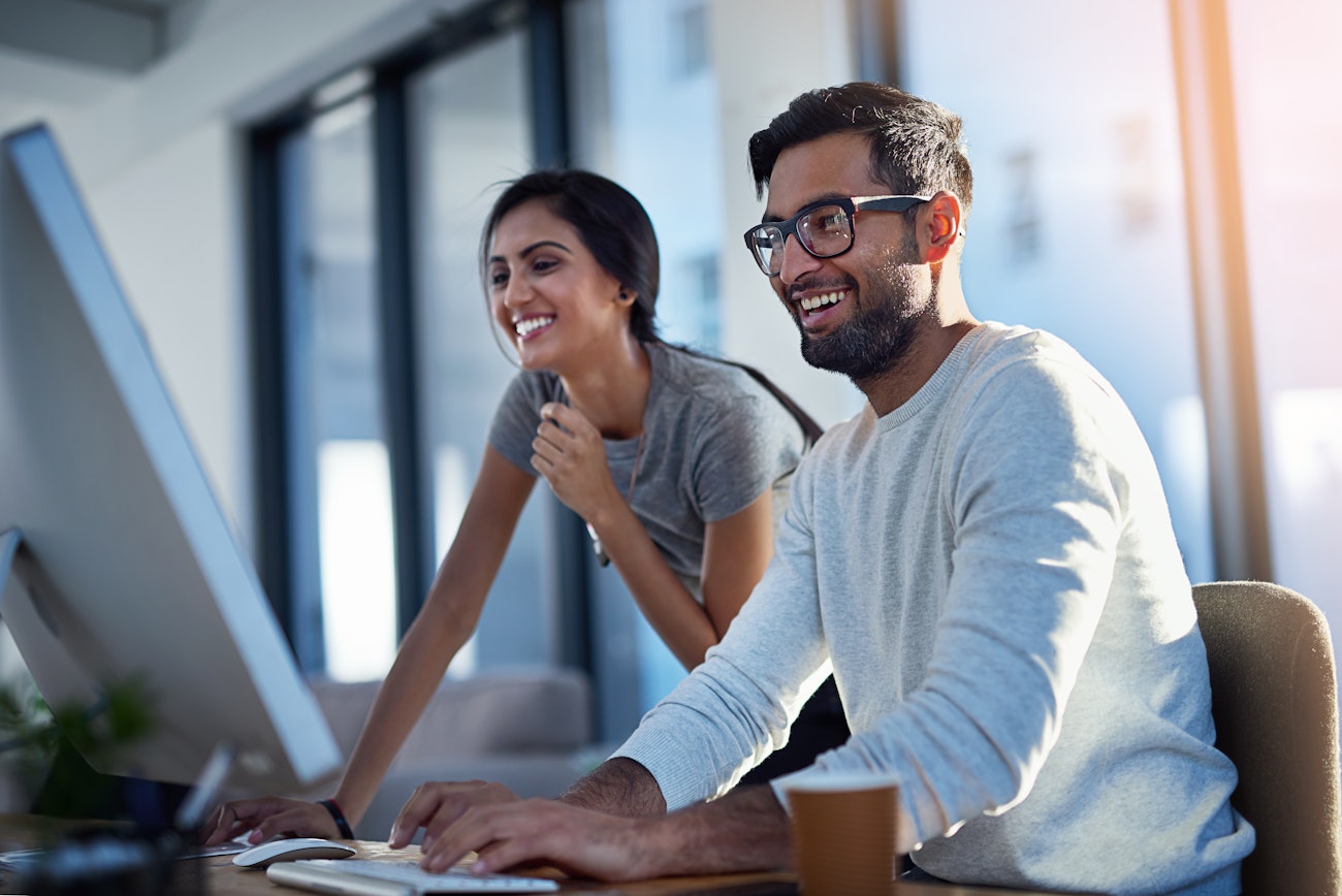 Woman man behind computer screen