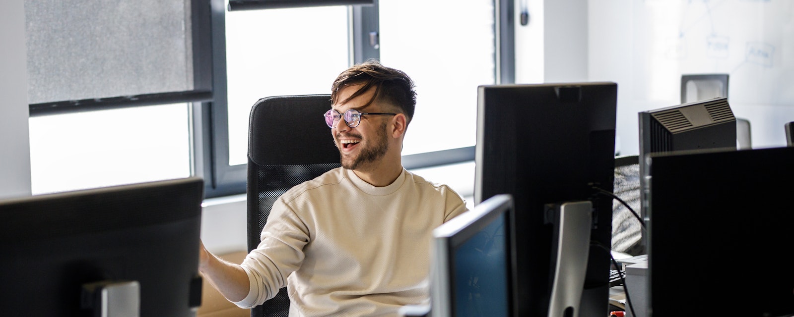 Engineer laughing behind desk