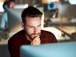 Man sitting behind screen thinking