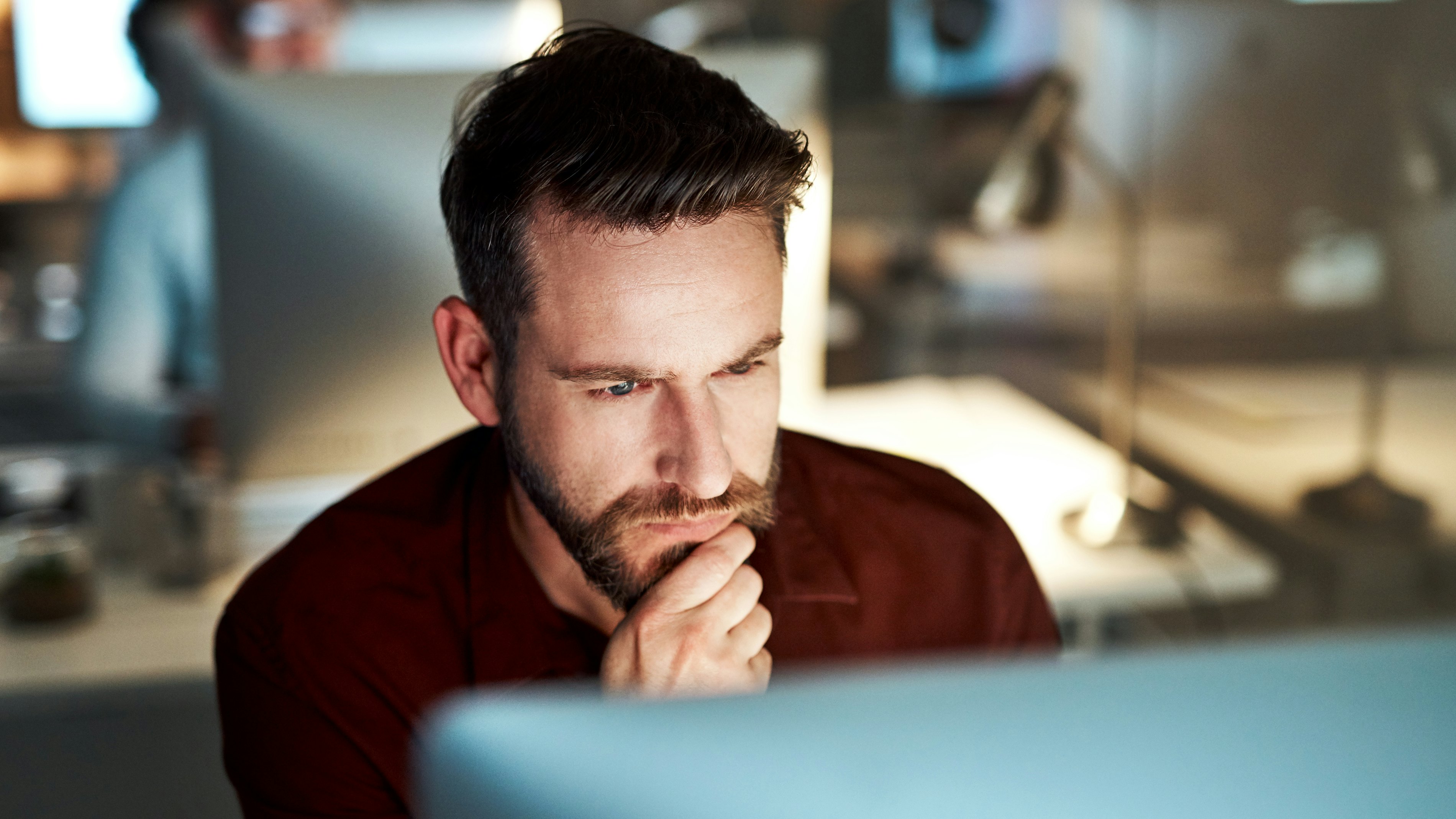 Man sitting behind screen thinking