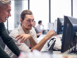 2 persons behind a screen