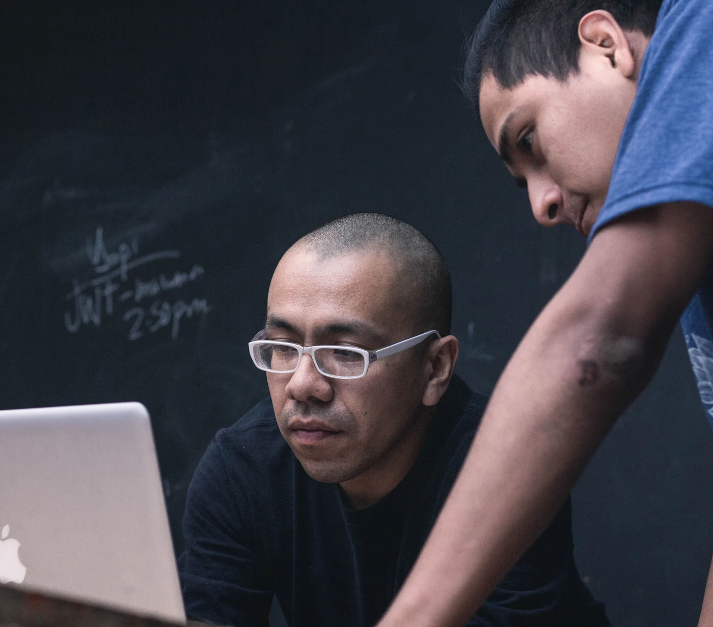 Two men looking at a laptop