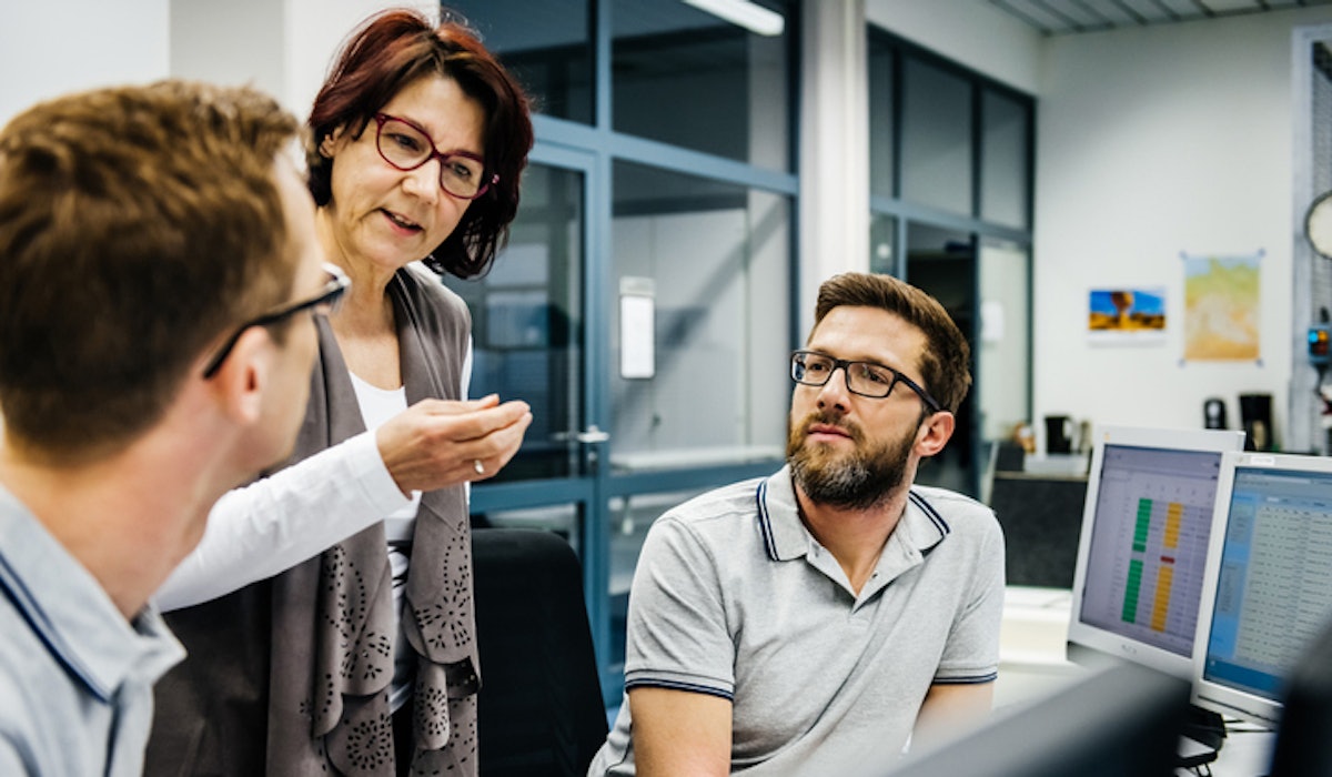 Senior female manager with two engineers