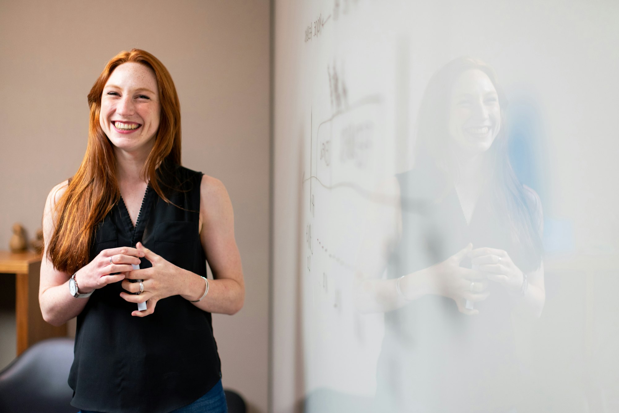 Smiling female engineer whiteboard