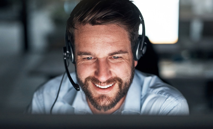 Support engineer with headset smiling