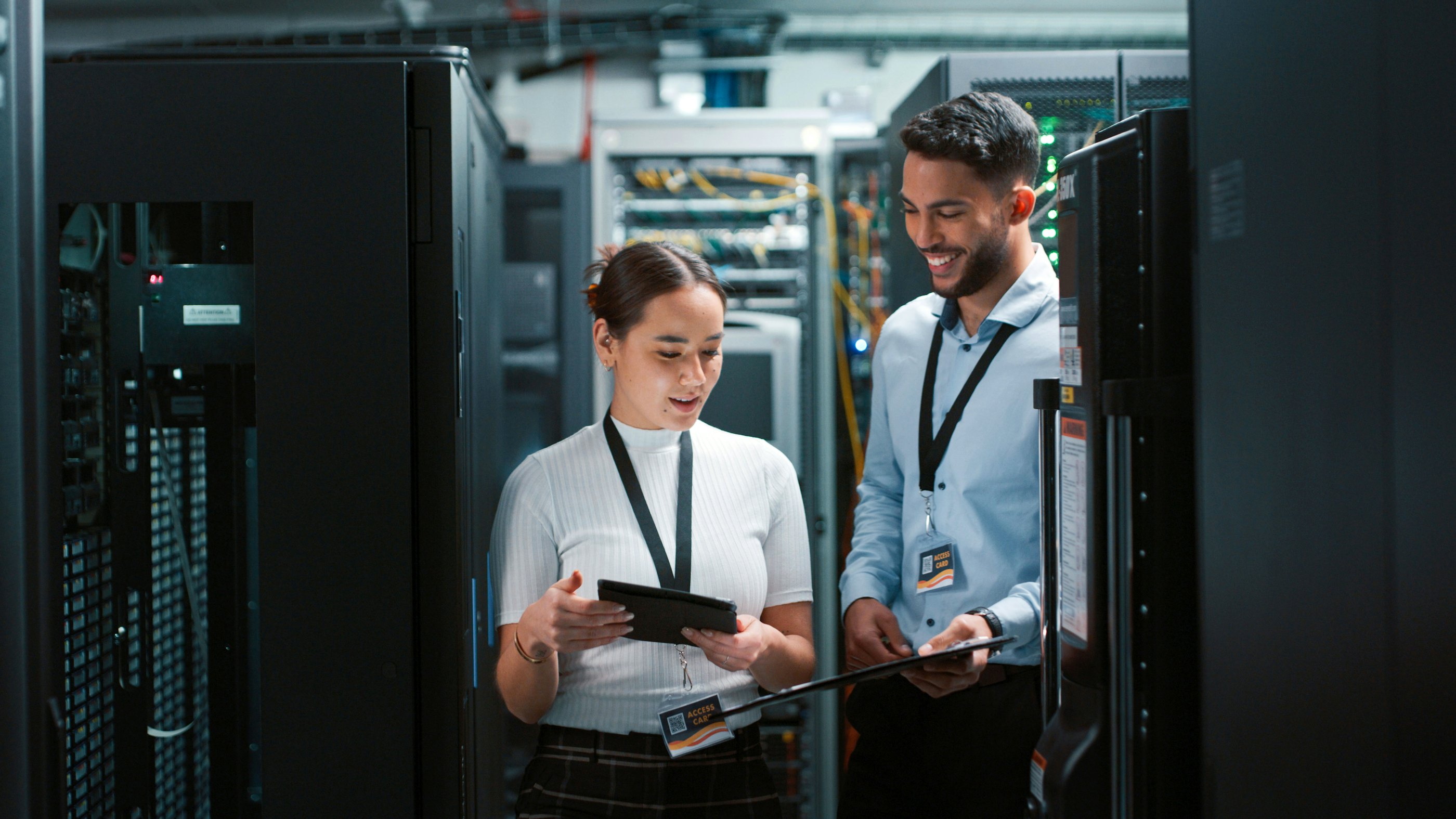 Two engineers datacenter smiling