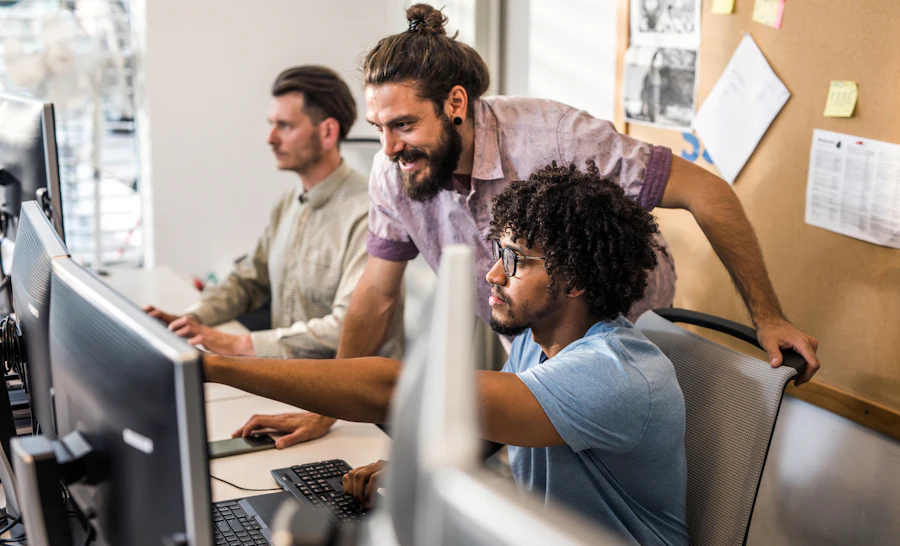 Two engineers laughing behind screen