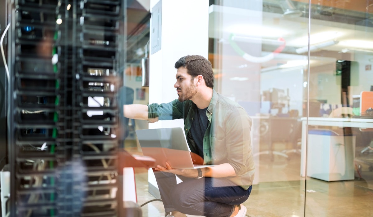 Young engineer datacenter room