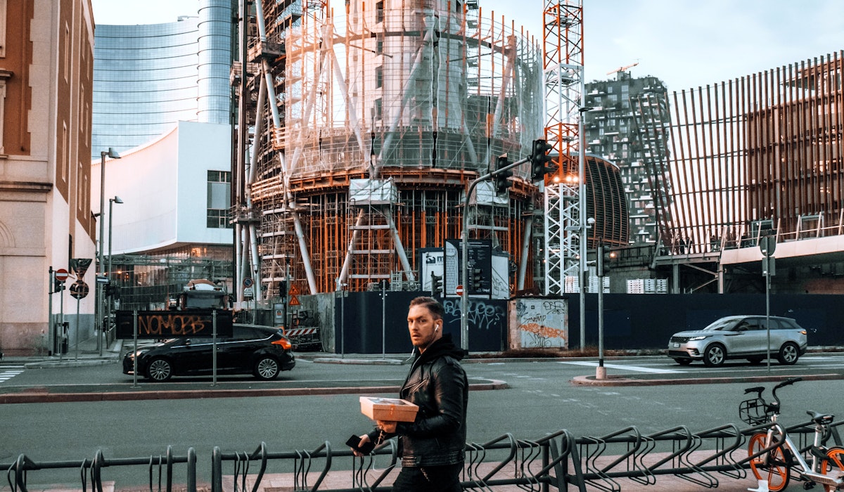 Man walking with package construction site