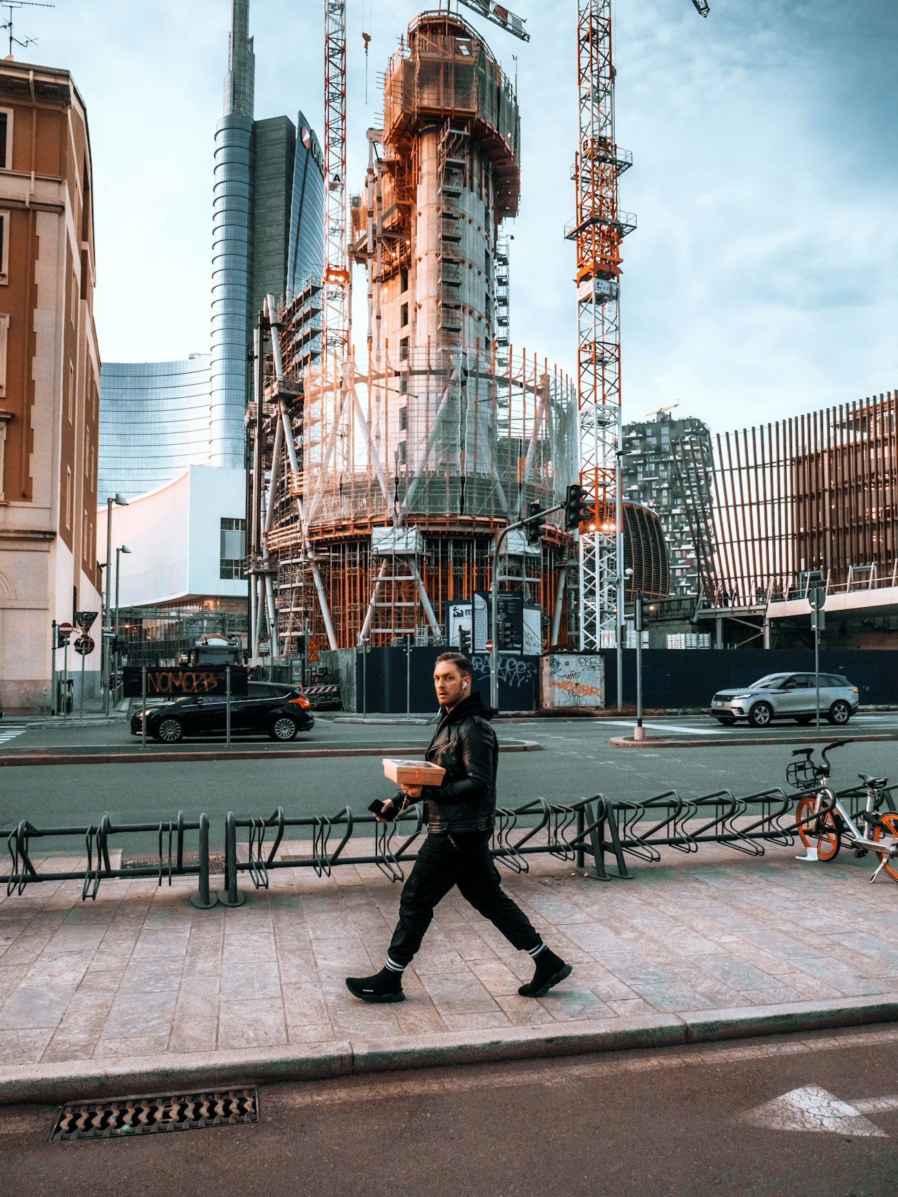 Man walking with package construction site