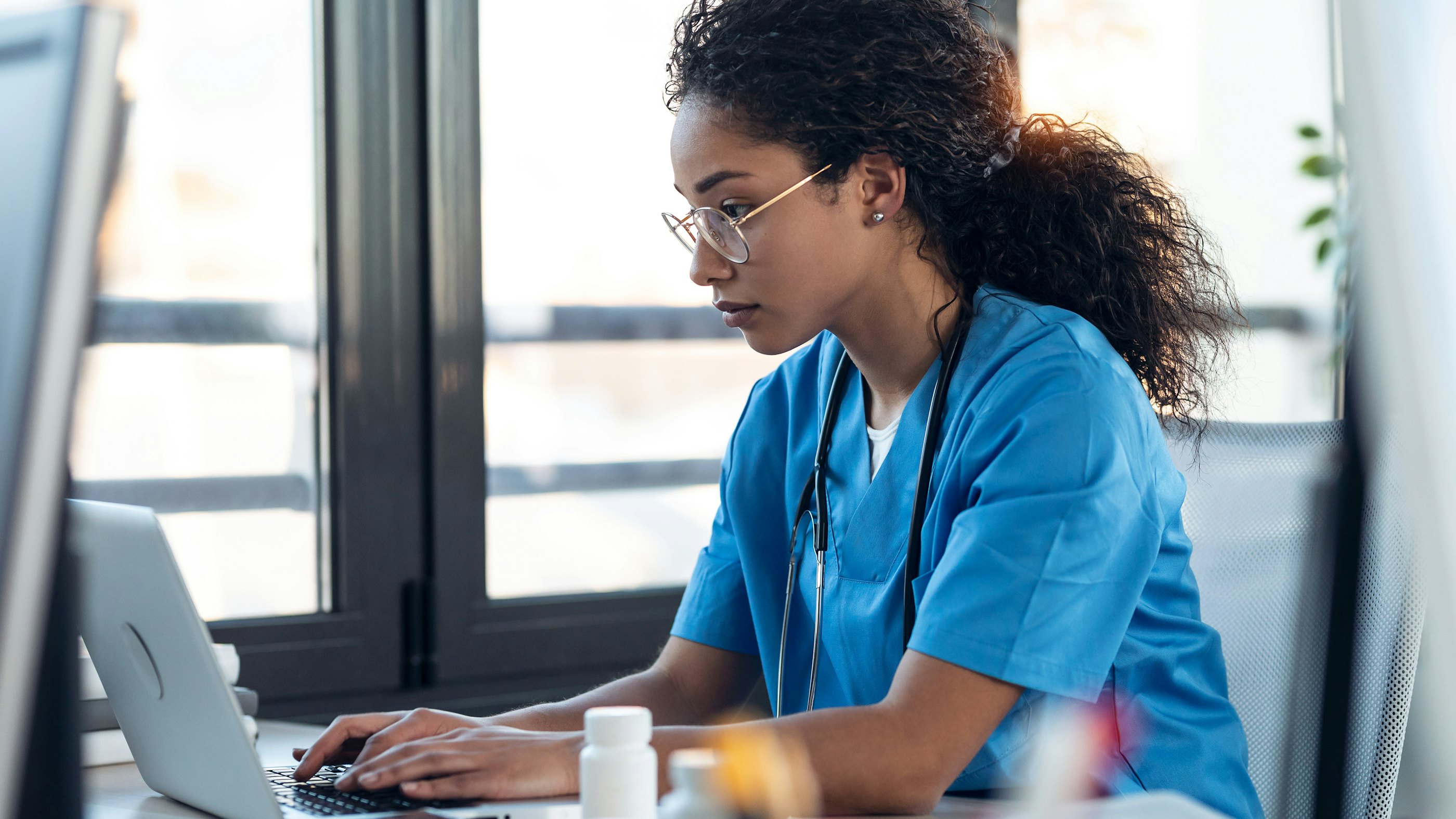 Nurse behind laptop healthcare
