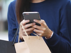 Retail shopper bags smartphone