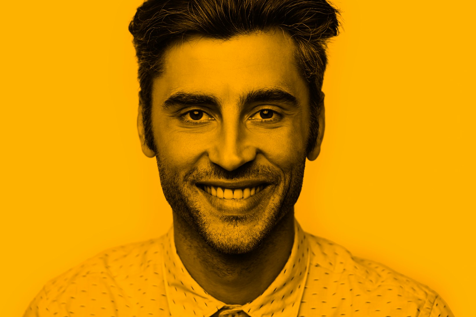 Portrait of ethnic male smiling dotted shirt