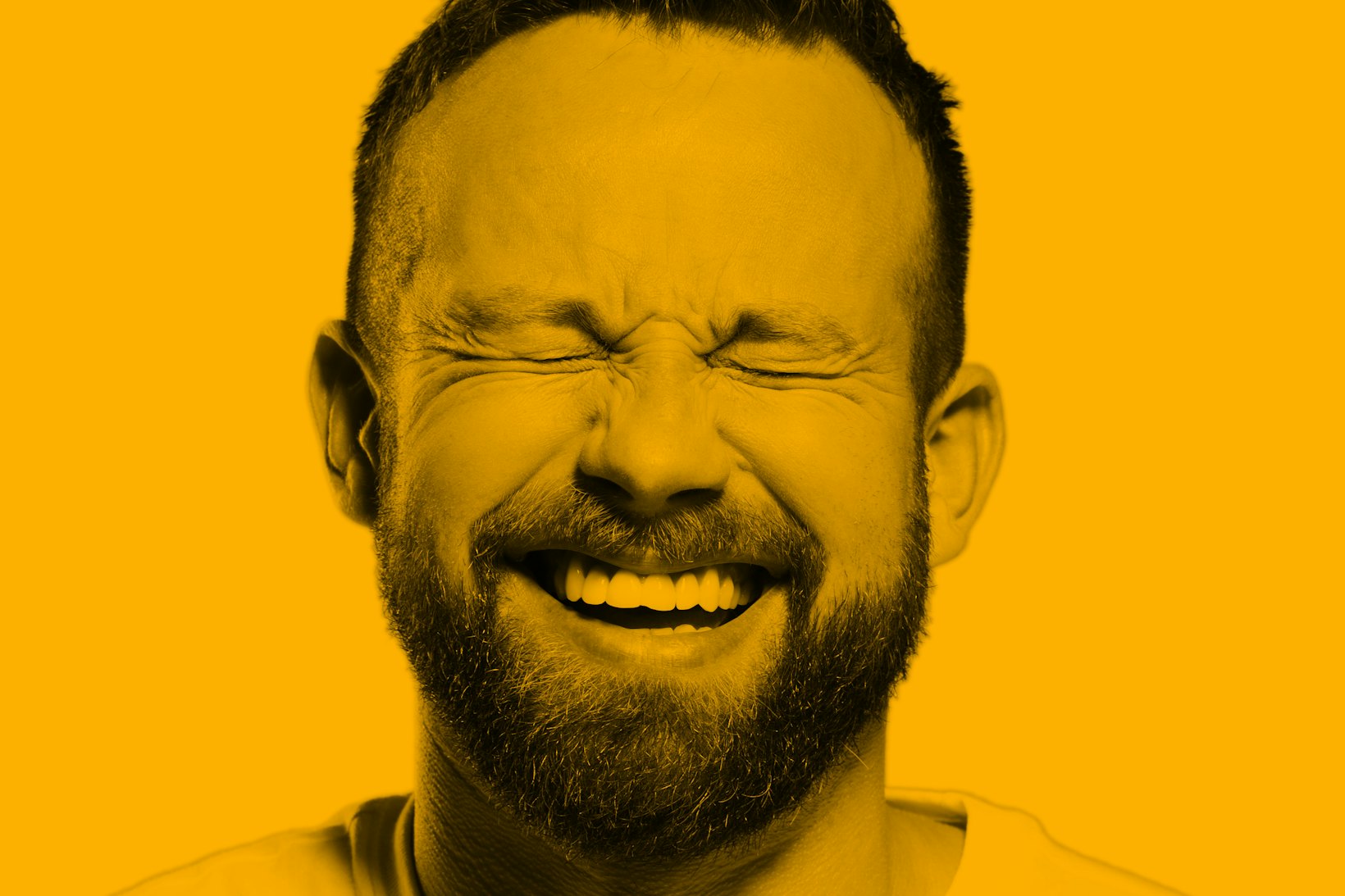 Portrait of guy smiling eyes closed