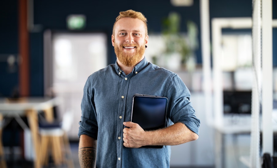 Portrait of man holding tablet