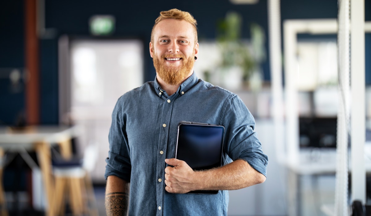 Portrait of man holding tablet