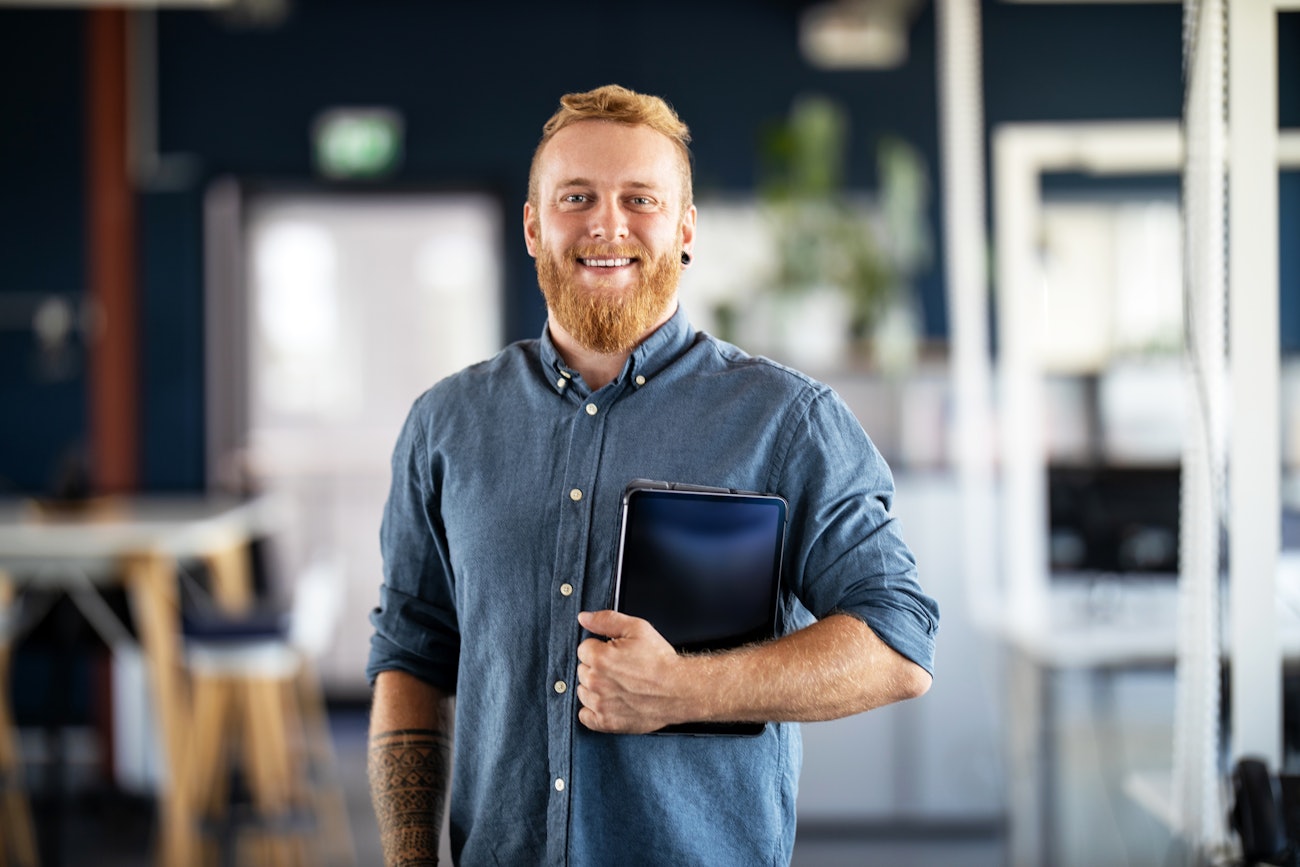 Portrait of man holding tablet