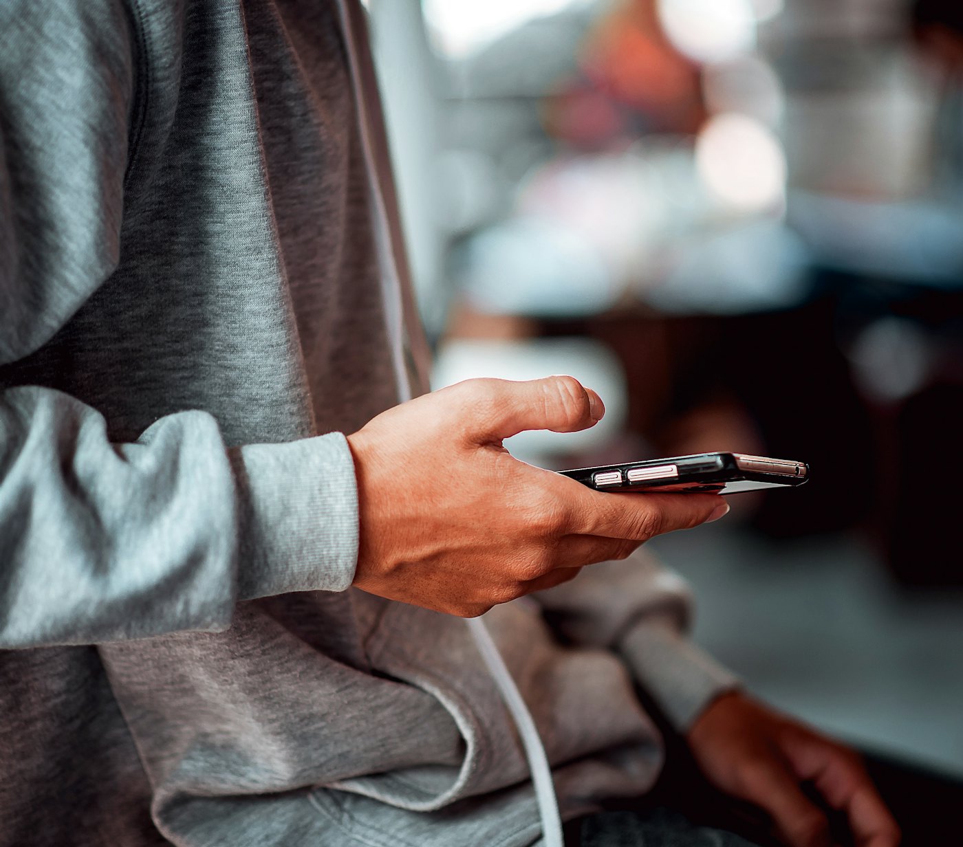 Closeup young man holding smartphone