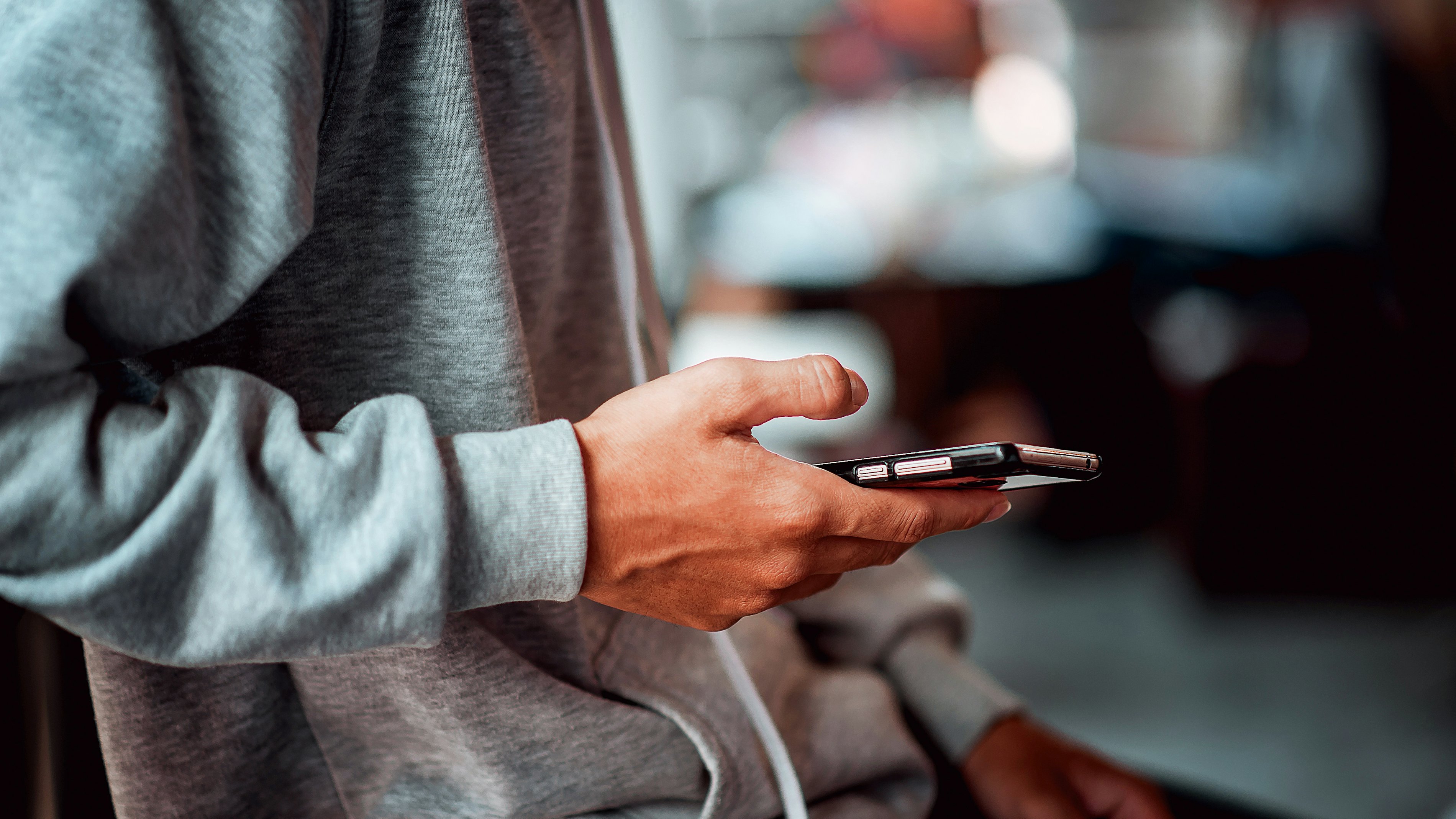 Closeup young man holding smartphone