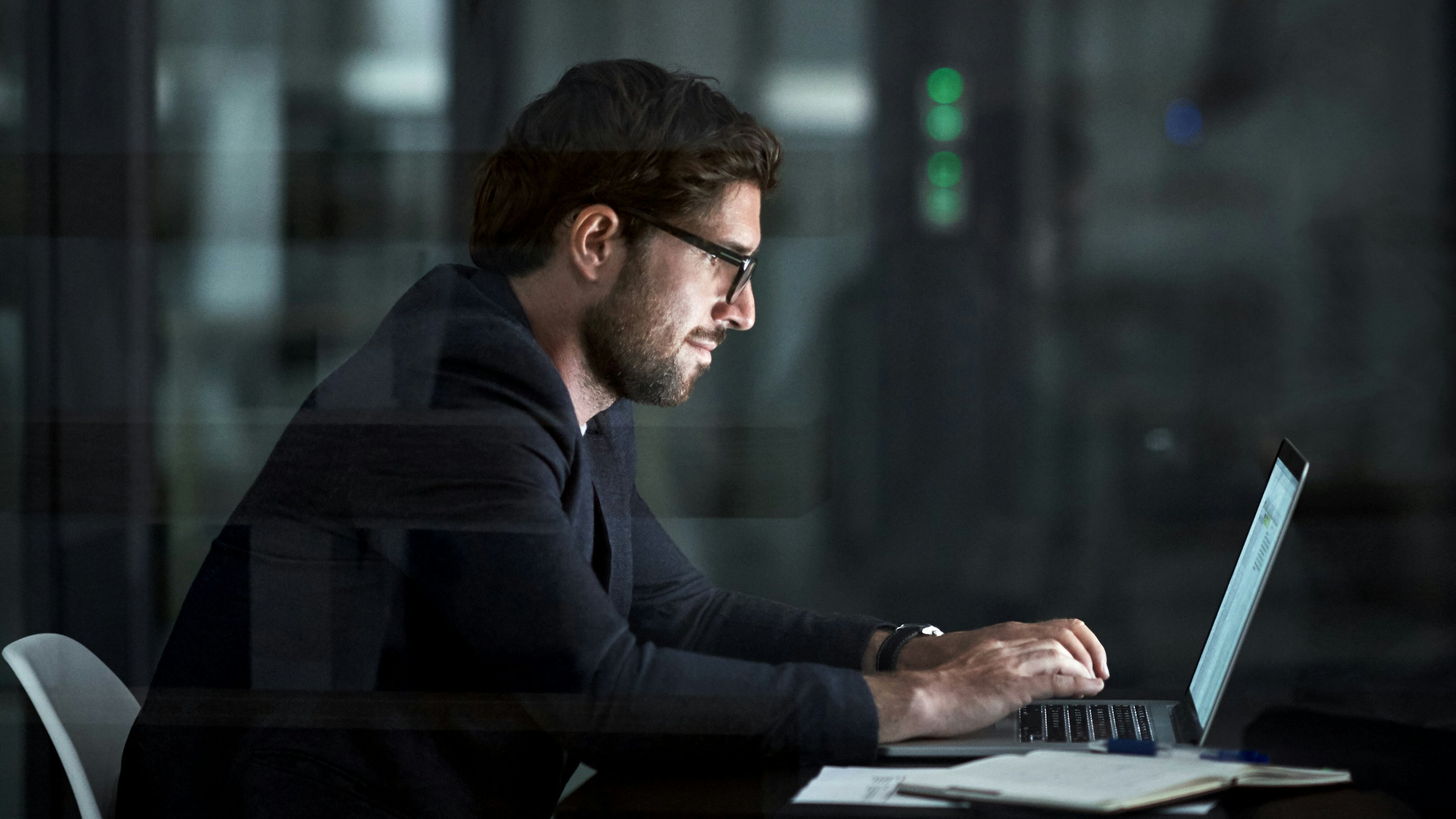 Man sitting behind laptop quantum computing threat