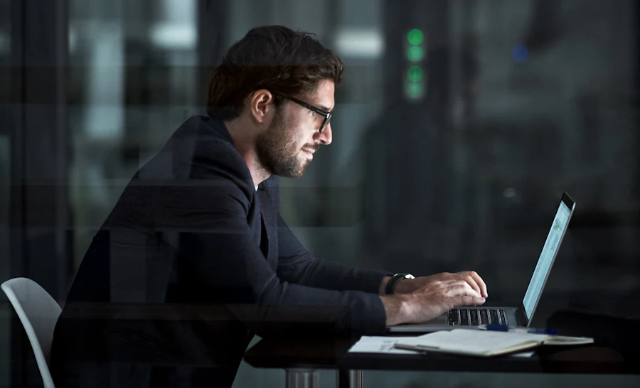 Man sitting behind laptop quantum computing threat