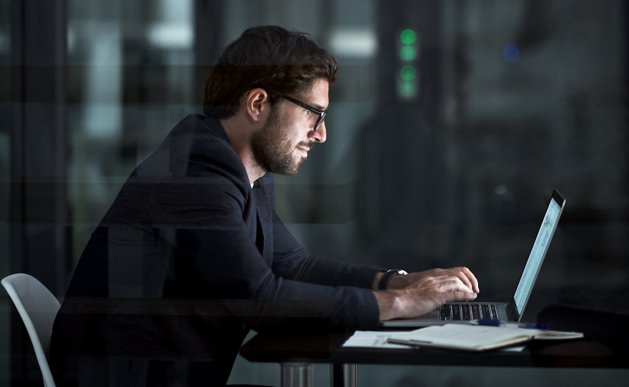 Man sitting behind laptop quantum computing threat