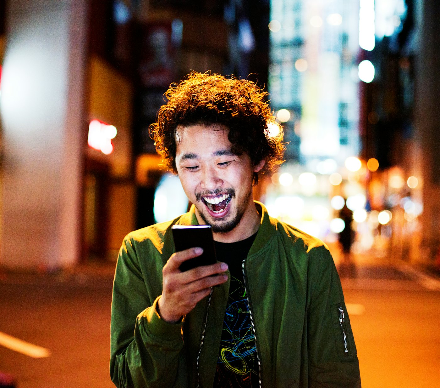 Japanese man laughing with phone