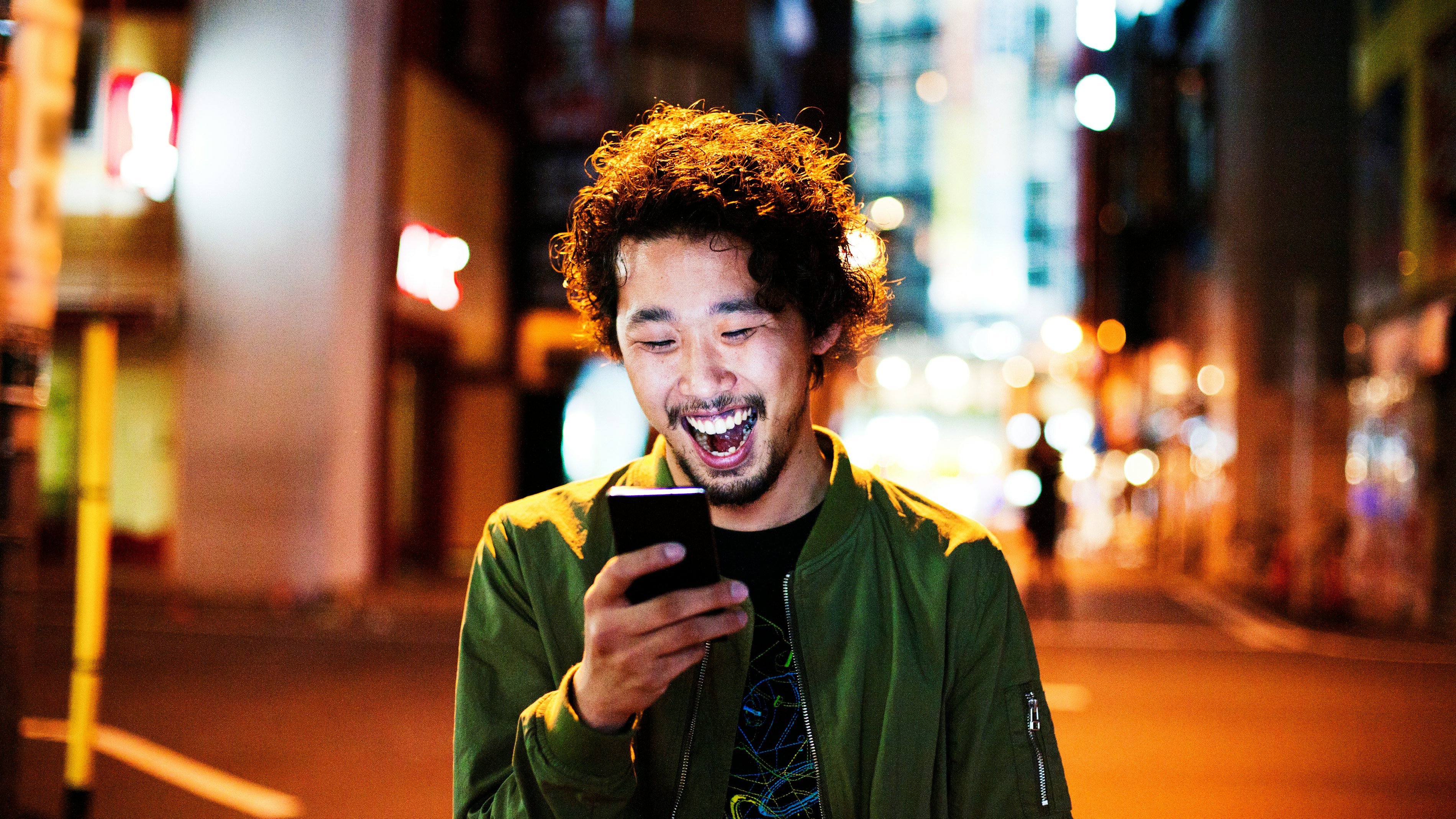 Japanese man laughing with phone