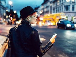 Woman in city checking directions maps
