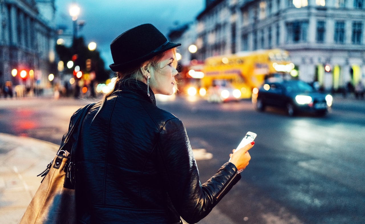 Woman in city checking directions maps