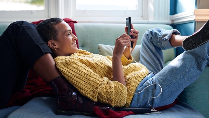 Woman relaxing on sofa smartphone
