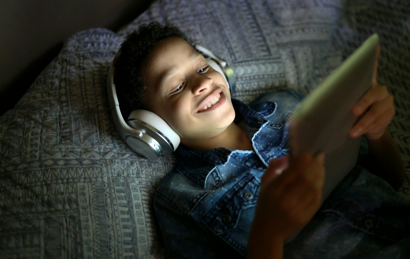 Young boy watching tablet headphones