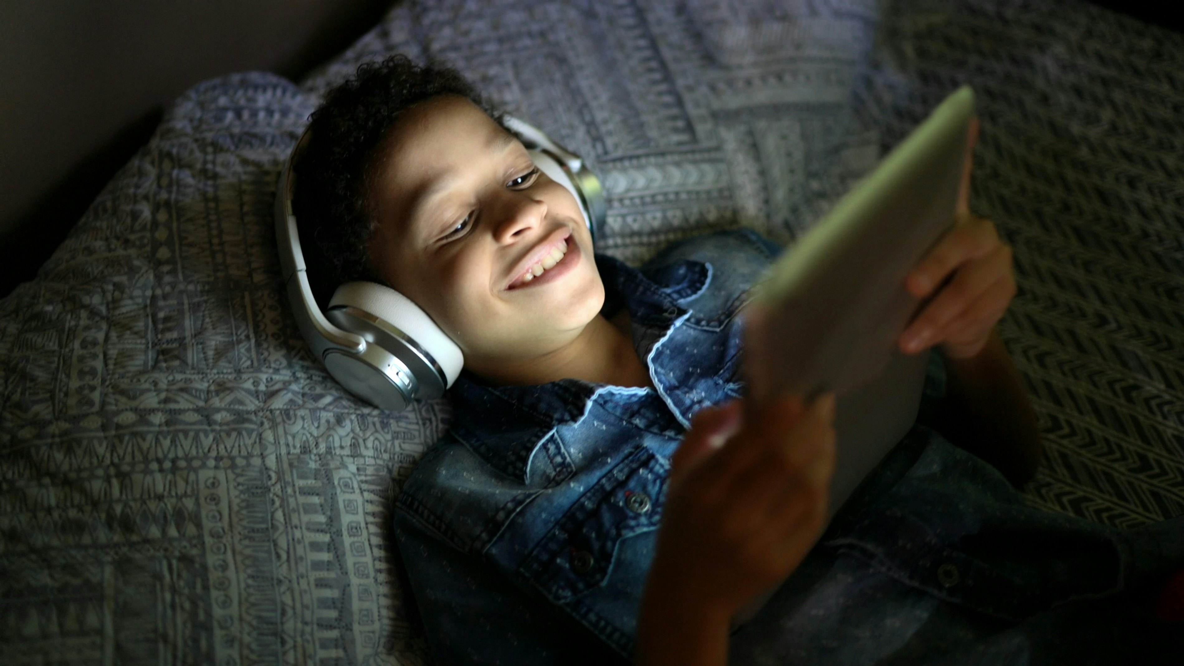 Boy watching tablet headphones