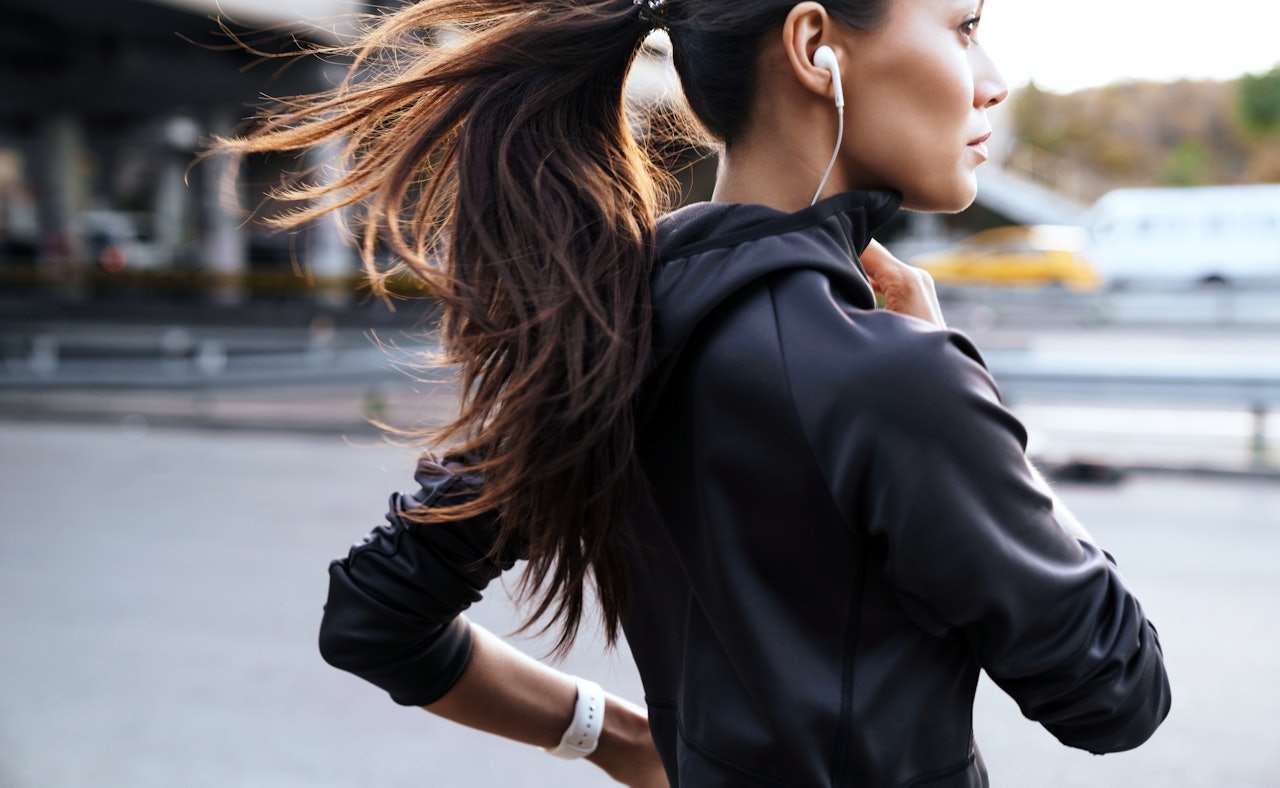 Young woman running smartphone