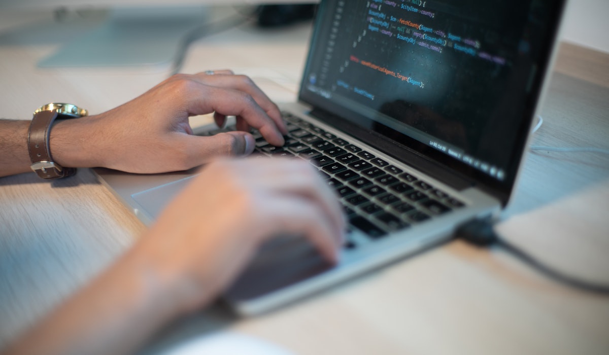 Close up of man coding on laptop scopio 39e6dc1c 65ff 4f46 9c9e cc5cc18cb5e3