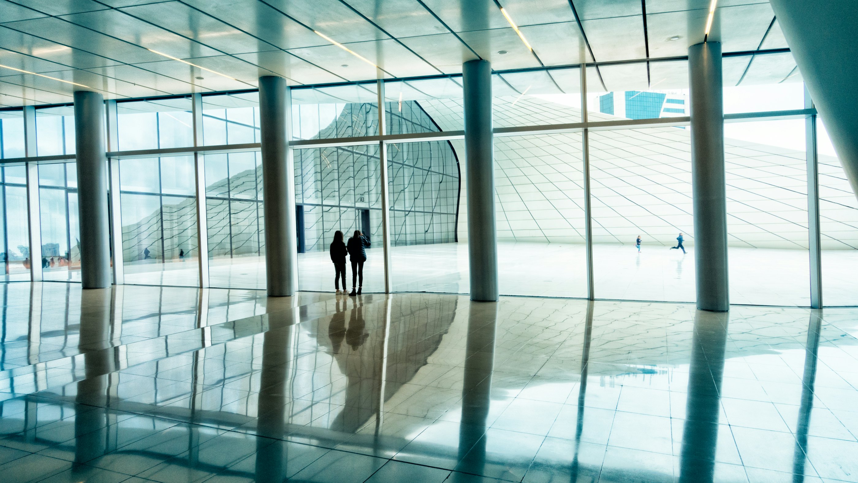 Person walking on white floor tiles scopio 4b10bfbb dcf5 4e1d a1fe ed31771f934c