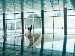 Person walking on white floor tiles scopio 4b10bfbb dcf5 4e1d a1fe ed31771f934c