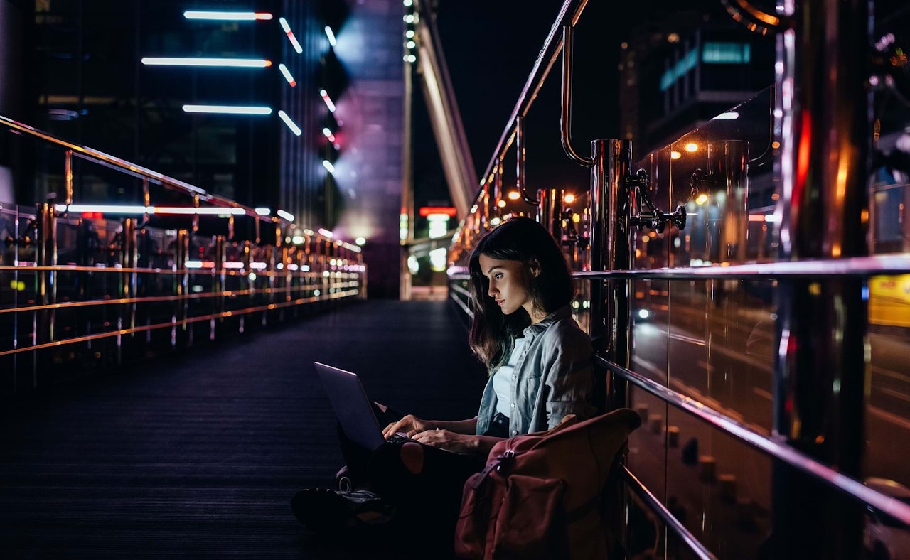 Girl on bridge laptop