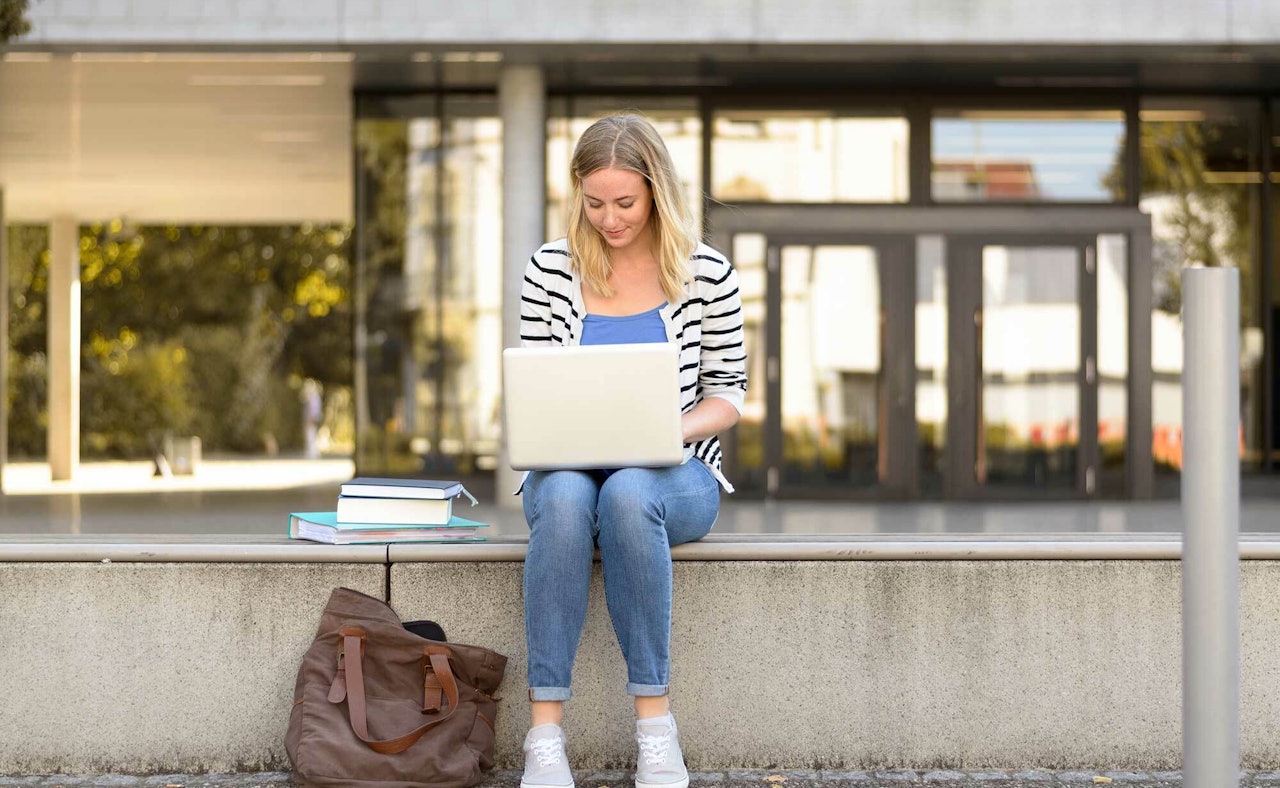 Student outside laptop